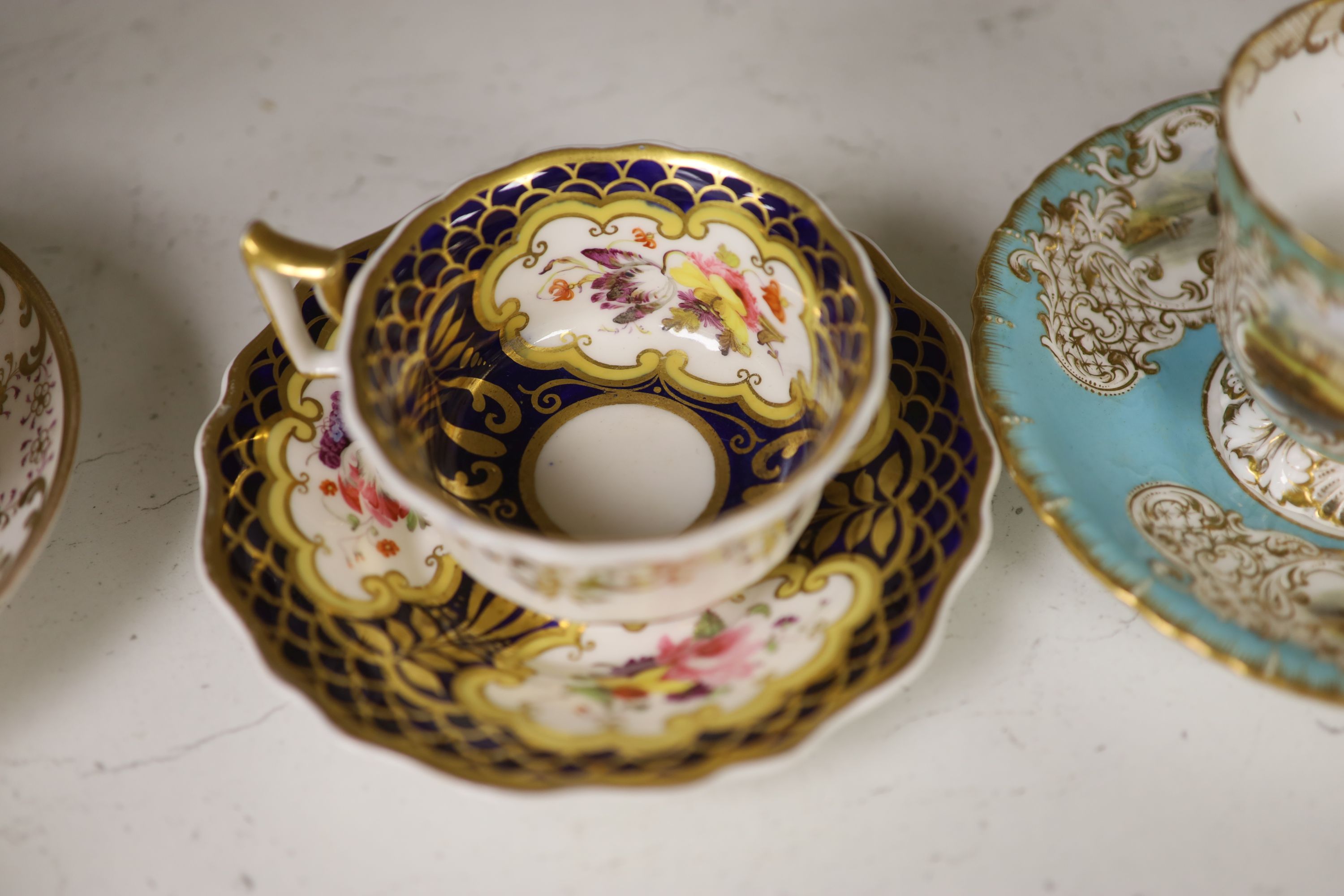 A Spode cup and saucer decorated with raised gilt birds and a basket with green leaves, marked Spode 3916, a Copeland and Garrett turqu